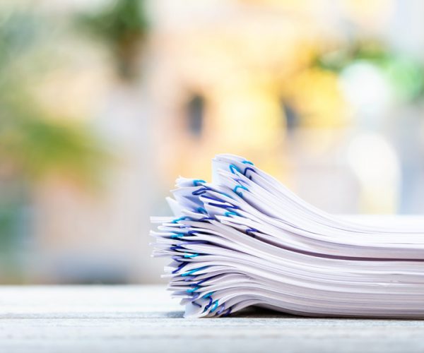 A stack of documents on a bright background