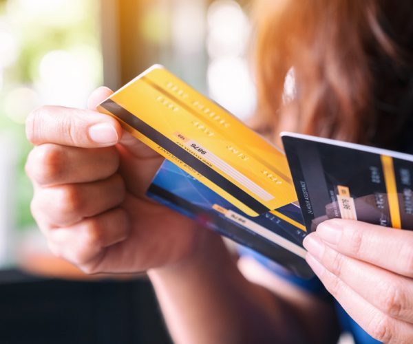 Closeup image of a woman holding and choosing credit card to use