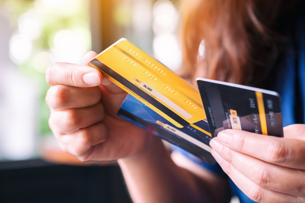 Closeup image of a woman holding and choosing credit card to use