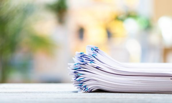 A stack of documents on a bright background